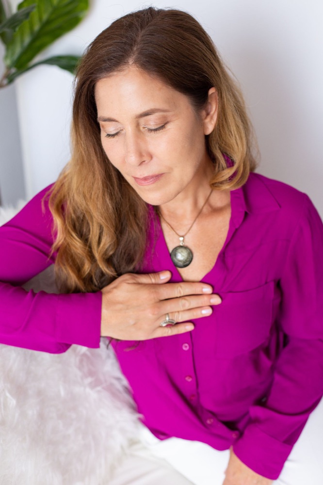 Sienna with her hand resting on her heart